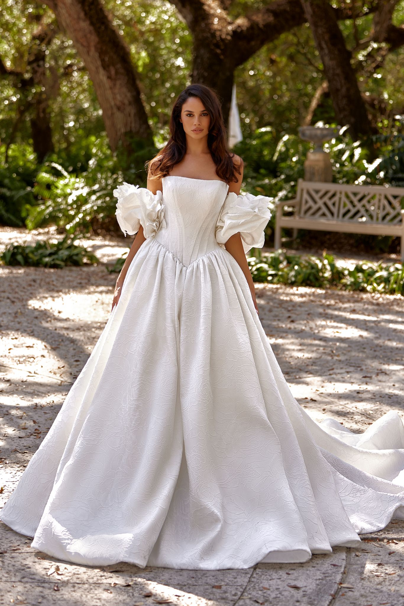 Edvina jacquard wedding dress with elongated corset, puff sleeves and floral texture.