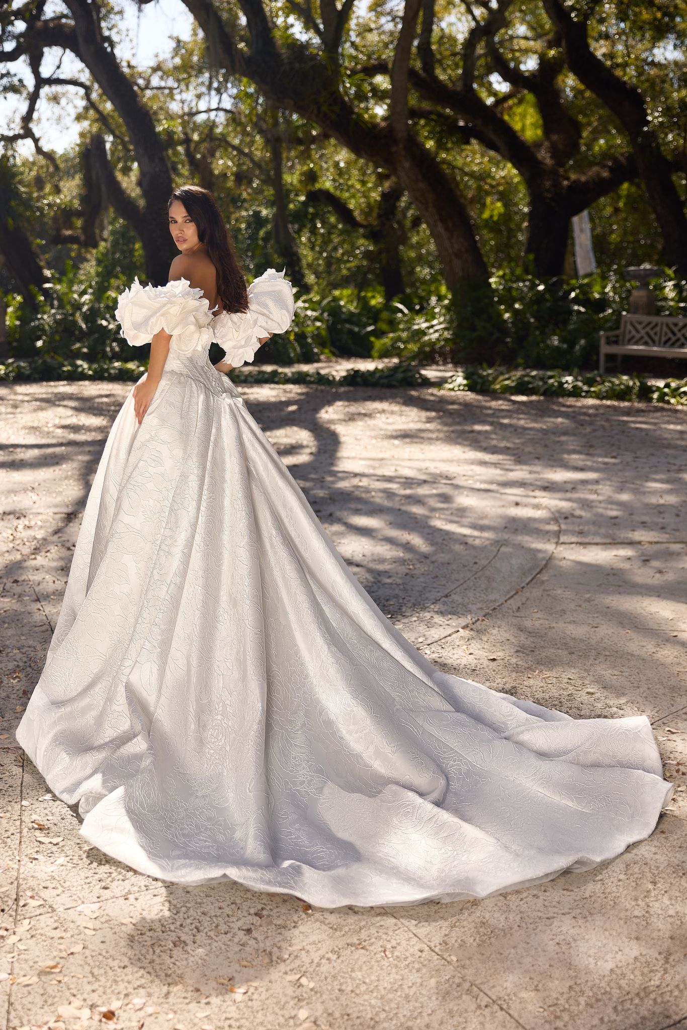 Regal Edvina bridal gown with full patterned skirt and handmade flower details.