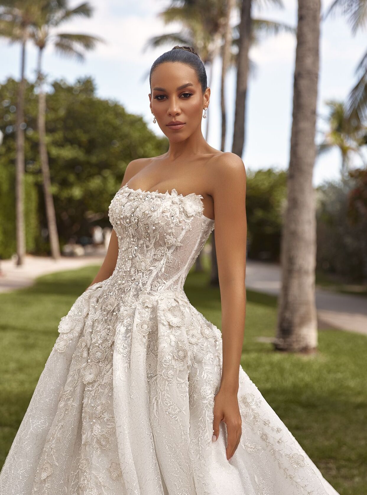 Lyra bridal gown: dramatic pleated skirt with open back and sparkling lace details